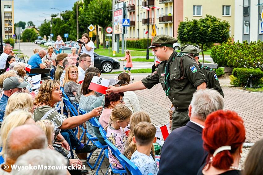 Wysokie Mazowieckie: harcerz rozdaje biało-czerwone flagi publiczności koncertu
